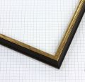 This 3/4 " profile frame features a very small edged extended back design with a subtle lip, finished in a striking combination of black and gold. The contrast between the deep black edge and radiant gold leaf creates a sophisticated, timeless look ideal for fine art and elegant displays.